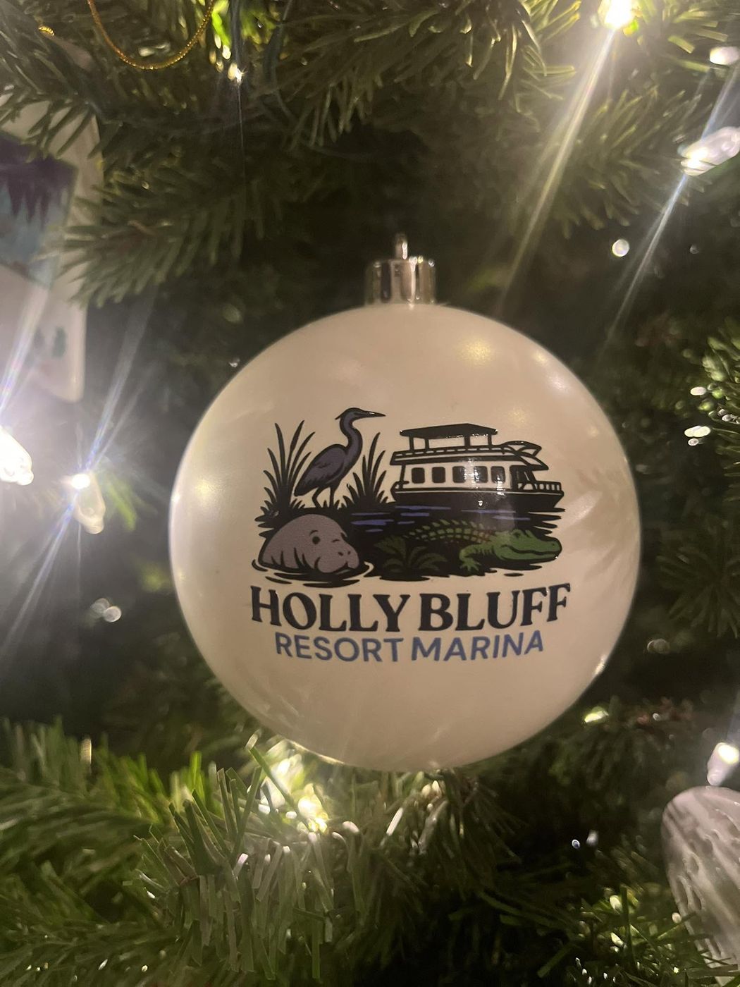 Oversized custom ornament on a lit commercial tree at Holly Bluff Resort Marina